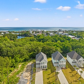 Aerial view showcases three modern vacation homes.
