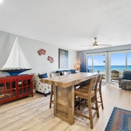 Your beach home combines coastal charm with comfort—rustic dining table, nautical décor, and stunning ocean views create the perfect seaside retreat.