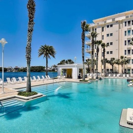 Stunning waterfront pool with crystal-clear waters, swaying palms, and sunbeds awaits your arrival. The scenic lagoon backdrop creates a peaceful retreat for relaxation and enjoyment.