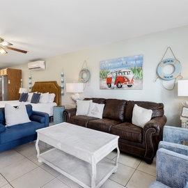 Relax in your bright, beach-themed living space where coastal charm meets comfort with plush seating and nautical touches.