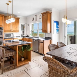 Your fully-equipped kitchen flows seamlessly into a dining space where ocean breezes and stunning sea views create the perfect backdrop for memorable meals.