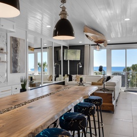 Your modern kitchen flows seamlessly into the living area, where ocean views frame every meal and moment of relaxation.
