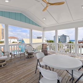 Covered terrace with panoramic sea views, dining, and relaxing seating.