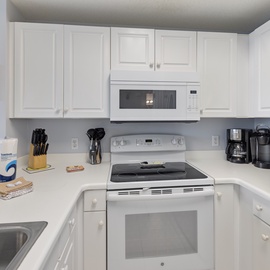 You'll love preparing meals in this bright, fully equipped kitchen with modern appliances, ample counter space, and everything you need for your stay.