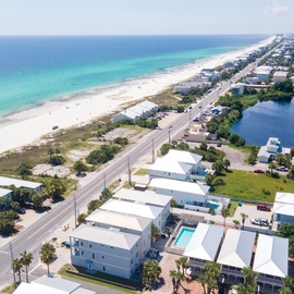 Stunning aerial view showcases pristine beaches and turquoise waters just steps from the property's prime coastal location.