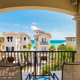 Your private balcony frames stunning turquoise waters and tropical palms, creating the perfect spot to sip morning coffee while watching the sea sparkle.