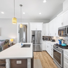 Your fully equipped chef's kitchen features stainless steel appliances, quartz countertops, and a stylish island perfect for meal prep.