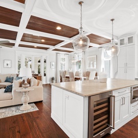 Your open-concept haven blends kitchen, dining, and living spaces under stunning wood-beam ceilings—perfect for memorable gatherings.