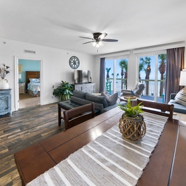 Relax in your bright living space with comfortable seating and stunning palm tree views from your private balcony.