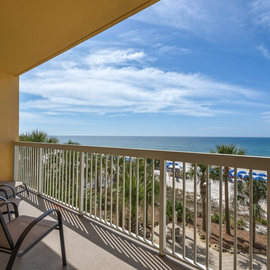 Sip your morning coffee from your private balcony as you watch waves dance across pristine sands and blue umbrellas dot the shoreline below.
