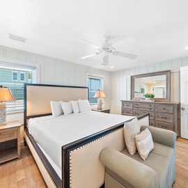 Sink into crisp linens and coastal comfort in your serene bedroom, where nautical charm meets modern luxury for perfect rest.