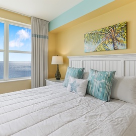 Wake up to endless ocean views from your cozy bedroom, where tropical colors and beachy vibes create the perfect seaside retreat.