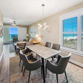 Gather around this stylish dining table where ocean views frame your morning coffee and evening meals become unforgettable moments.