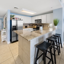 Your fully equipped kitchen features granite countertops, stainless steel appliances, and a breakfast bar where you can enjoy morning coffee together.