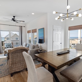 Bright, airy living and dining space with modern coastal style, plus stunning ocean views through every window to welcome your beach retreat.