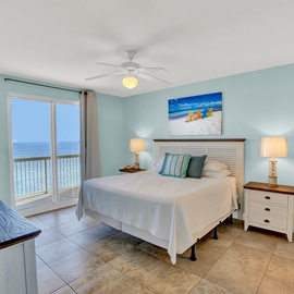Wake up to stunning ocean views from your peaceful bedroom, where coastal décor and sliding door balcony access create the perfect seaside retreat.