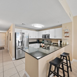 Your fully equipped kitchen features granite counters, stainless appliances, and a breakfast bar where you can sip morning coffee.