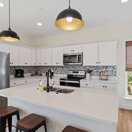 Cook in your fully-equipped modern kitchen with stylish pendant lighting and everything needed for home-cooked meals.