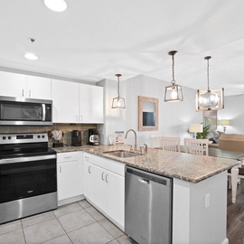 Your fully equipped kitchen features granite countertops, stainless appliances, and a breakfast bar where you can sip coffee while enjoying ocean views.