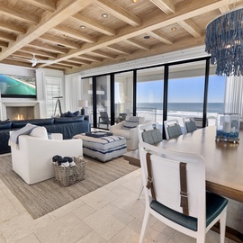 Unwind in your elegant beachfront sanctuary, where plush seating, a warm fireplace, and stunning ocean views create the perfect coastal retreat.