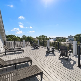 Stretch out on your spacious rooftop deck with comfortable lounge chairs, perfect for soaking up the sunshine and enjoying open-air relaxation high above the neighborhood.