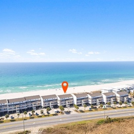 Beachfront property complex offering direct access to pristine sandy shores and crystal-clear waters along the coastal highway.