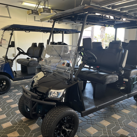 Multiple golf carts ready for your resort adventures, stored safely in the covered garage area.