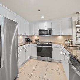 Your modern kitchen features granite counters, stainless appliances, and sleek white cabinets for all your culinary adventures.