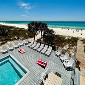 Beachfront property with pool deck, sunbeds, and direct beach access to pristine white sands and turquoise waters.
