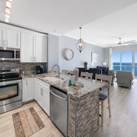 Your stunning oceanfront kitchen opens to breathtaking sea views, where cooking becomes a joy with granite counters and stainless appliances.