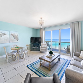 Your bright coastal living room flows seamlessly to the dining area, where ocean blues meet serene walls and stunning sea views await.