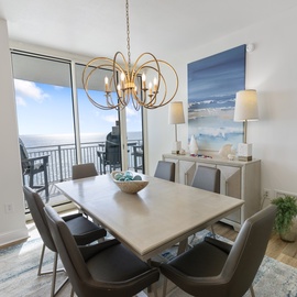Gather around this elegant dining table with stunning ocean views through your private balcony doors.