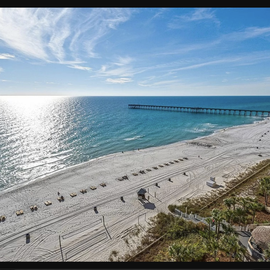 Stunning beachfront location with pristine white sand beach, fishing pier, and crystal-clear waters stretching to the horizon.