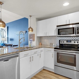 Your fully equipped kitchen features granite counters, stainless appliances, and an open layout perfect for preparing meals during your stay.