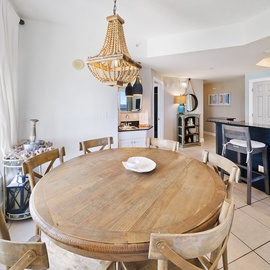 Gather around your beautiful dining table beneath the stunning chandelier while enjoying sweeping city views through floor-to-ceiling windows.
