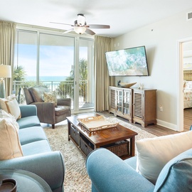 Sink into plush coastal seating where ocean breezes flow through your private balcony doors, creating the perfect spot for morning coffee.