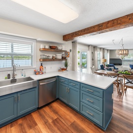 Your bright, modern kitchen features beautiful blue cabinets and flows seamlessly into the cozy living space—perfect for cooking and gathering together.