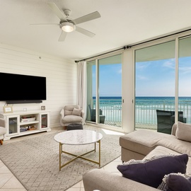 Relax in your bright living room with breathtaking ocean views through floor-to-ceiling windows. Sink into plush seating while enjoying the coastal breeze.