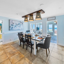 Gather around your coastal dining table where ocean views through every window make every meal feel like beachfront dining.