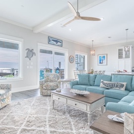 Sink into the plush turquoise sectional and let ocean breezes flow through your bright, coastal-inspired living space.