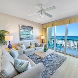 Relax in your oceanfront living room where tropical plants, comfy seating, and stunning sea views create your perfect beachside retreat.