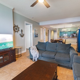 Your bright, coastal-inspired retreat features soft seating perfect for unwinding, with an open layout flowing into a cheerful kitchen. Thoughtful beach touches remind you of the waves just beyond.
