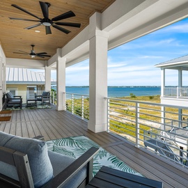 Breathe in the ocean breeze as you relax on your private covered deck with sweeping sea views and comfortable seating.