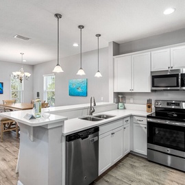 Your fully equipped kitchen awaits with modern appliances, spacious countertops, and a breakfast bar where you can start each morning right.