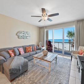 Relax in your spacious oceanfront living room where soft sofas and stunning sea views create the perfect beachside retreat.