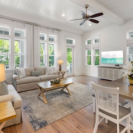 Settle into this bright, airy living space where soft coastal tones and abundant natural light create your perfect retreat. Relax on plush seating, enjoy meals at the stylish dining table, and let the serene atmosphere make you feel right at home.