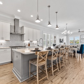 Your spacious open-concept kitchen invites culinary adventures with gleaming countertops, modern appliances, and a stunning island for gathering.
