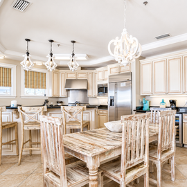 Your gourmet kitchen welcomes you with granite counters, elegant pendant lighting, and a rustic dining table perfect for sharing meals.