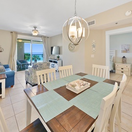 Gather around the spacious dining table with ocean views streaming through your balcony doors, perfect for memorable meals.