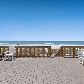 Relax in your private beachfront paradise where morning coffee meets ocean breeze on this expansive deck.